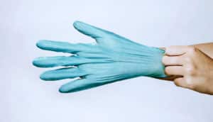 putting on medical glove (infectious disease specialists concept)