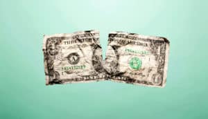 ripped dollar bill (millennials + retirement accounts concept)