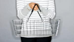 person holds shopping basket