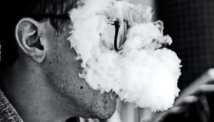 smoke covering mans face (marijuana concept)