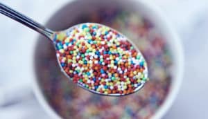 sprinkles on spoon (sugar molecules and UTIs concept)