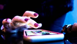 using smartphone with purple nails (blood pressure concept)