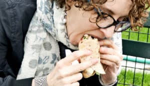 woman eats wrap -- hunger