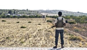man holding rifle in Syria