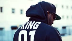 man facing away in hoodie and hat - prison and obesity