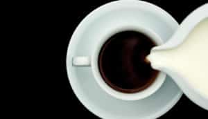 pouring milk into coffee
