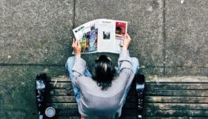 high angle shot of man reading paper