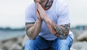 seated man with tattoos