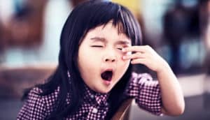 young girl yawning