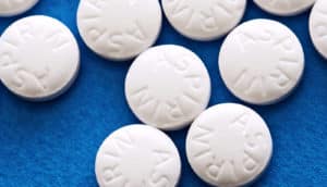 aspirin pills on blue