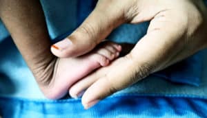 baby foot in moms hand