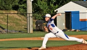 high school pitcher throwing baseball