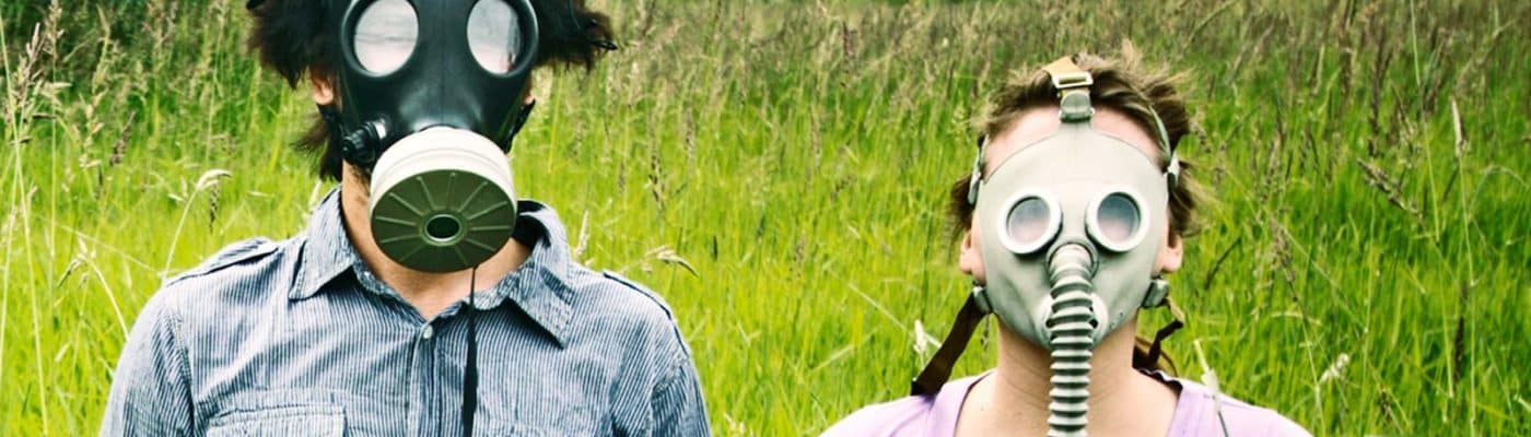 man and woman in gas masks - behavioral immune system