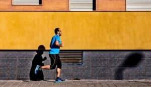 man running past orange wall