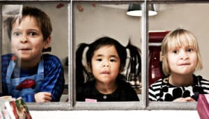 three kids smush faces against window - kindergarten readiness