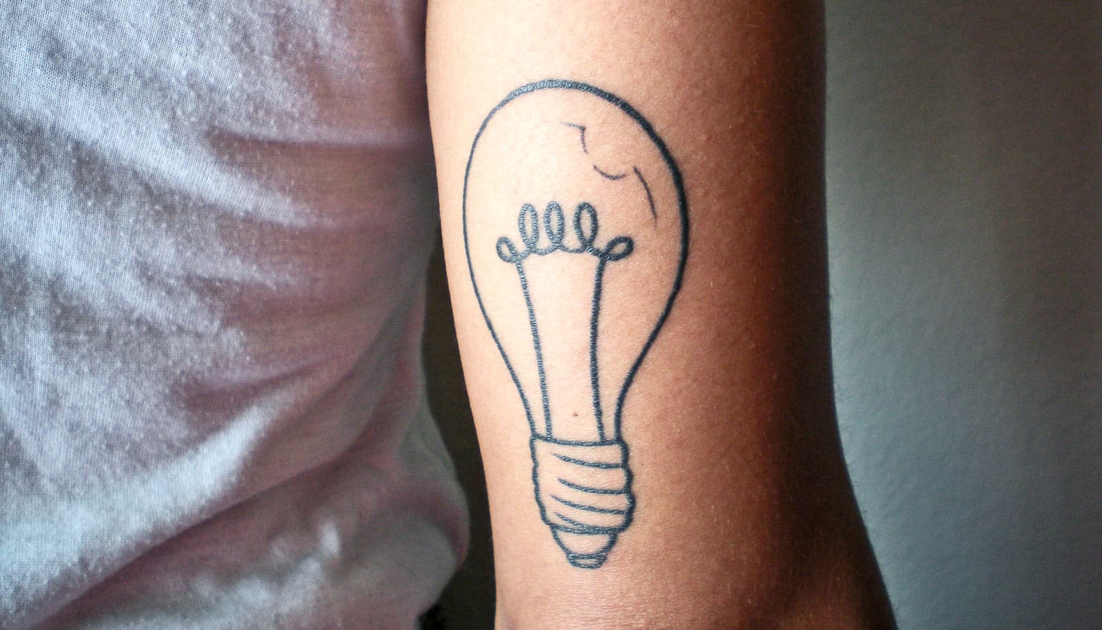 Light bulb tattoo on the wrist.