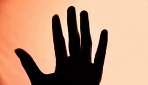 hand silhouette on orange - Fingerping