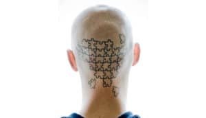 puzzle tattoo on back of head