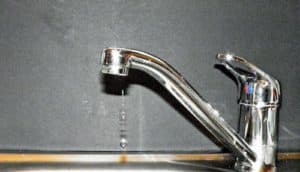 silver faucet dripping water