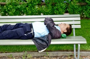 man asleep on park bench - sleep and memory