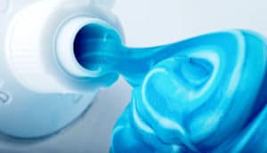 toothpaste spilling from tube (cystic fibrosis concept)