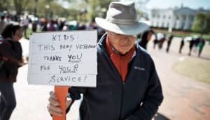 veteran with sign supporting anti-NRA rally