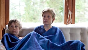 brothers on couch with blue blanket - siblings