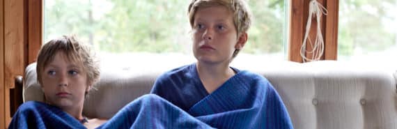 brothers on couch with blue blanket - siblings