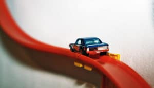 matchbox car on red track - axonal transport