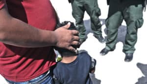 father and son detained by border patrol (child separation concept)