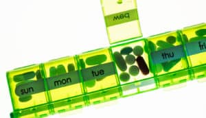 green pill case - biotin supplements