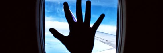 hand on airplane window (airplane cabins concept)