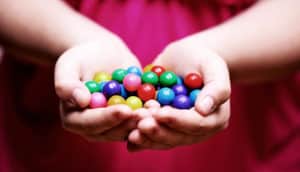 little kid holding candy