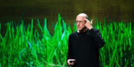 Michael Pollan on stage, pointing at head