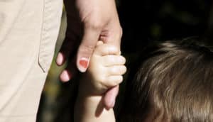 mom holding kids hand (cancer concept)
