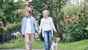 older couple walking the dog (obesity concept)