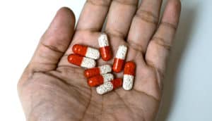 red and white pills in palm