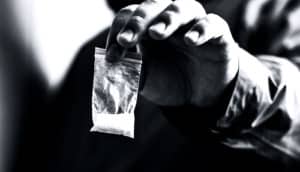 powder in baggie in hand (teen heroin use)