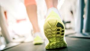 yellow sole of sneaker on treadmill - rehabilitation robotics