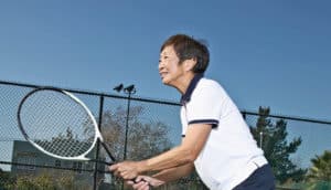 older woman playing tennis
