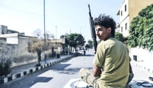 young man in Syria with rifle