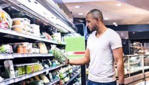 checking food label (genetically engineered foods concept)