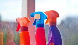 cleaning bottles near dirty window