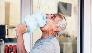 older man eating cotton candy