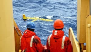 two researchers observe float in water
