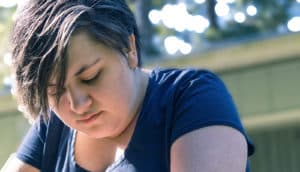 young woman hangs her head
