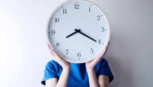 clock over face (circadian rhythm concept)
