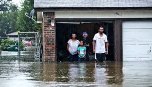 family at flooded home (home buyout concept)