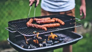 man cooking hot dogs (meats concept)