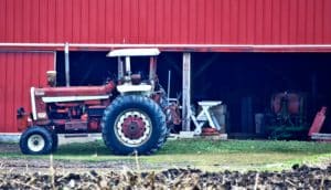 red tractor on farm (tariffs concept)
